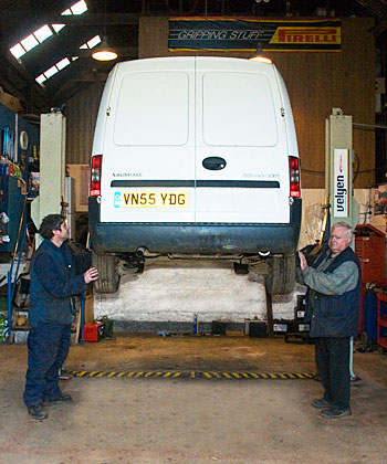 Auto Mechanics working in Vehicle Maintenance Bay